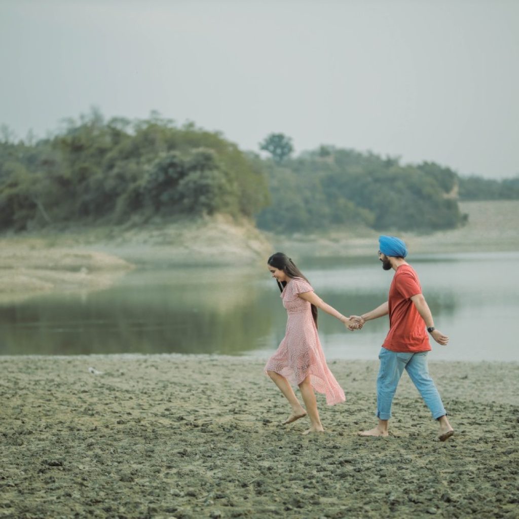 Candid photography- Couple having romantic walk alongside lake