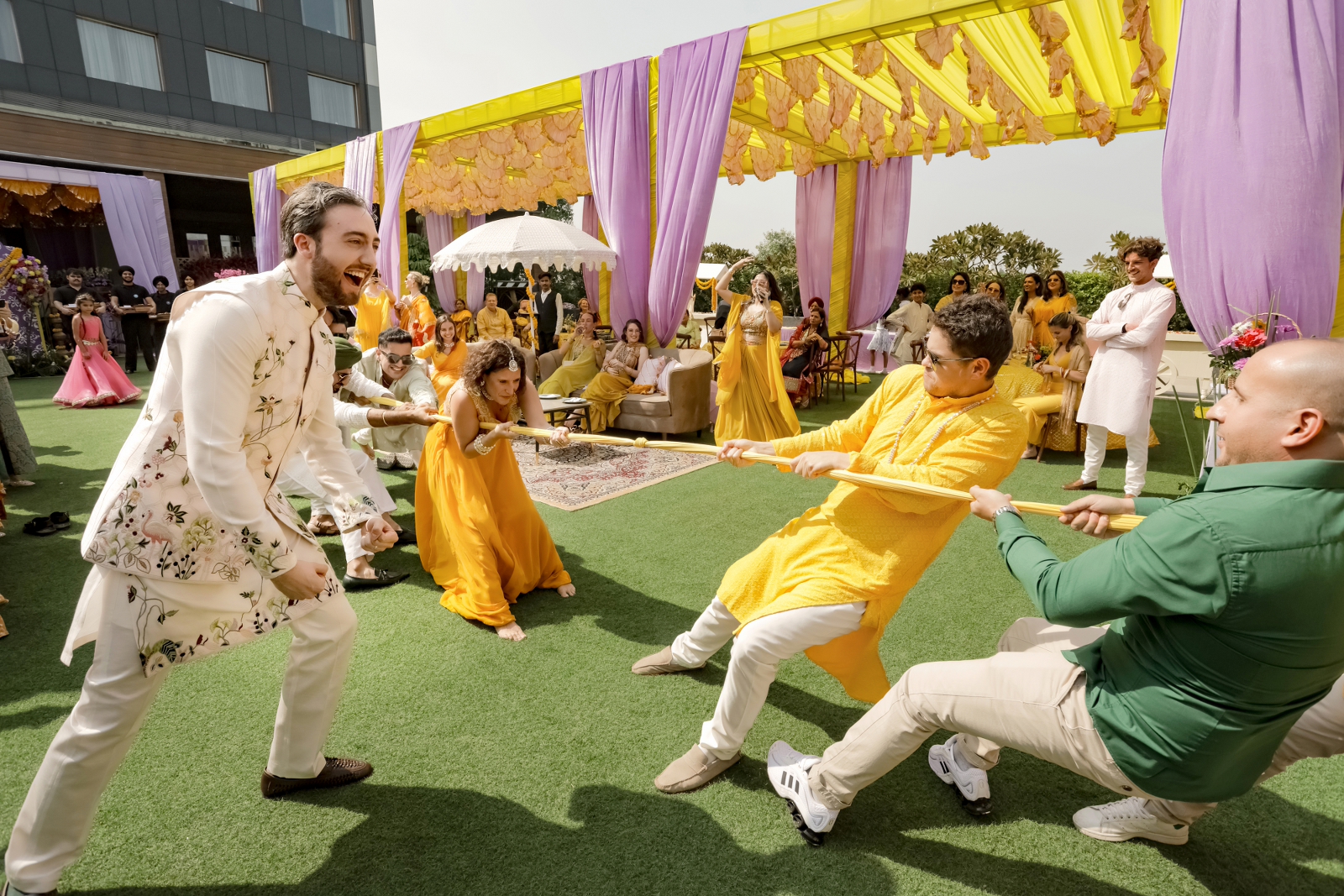 Guests playing tug of war during destination wedding