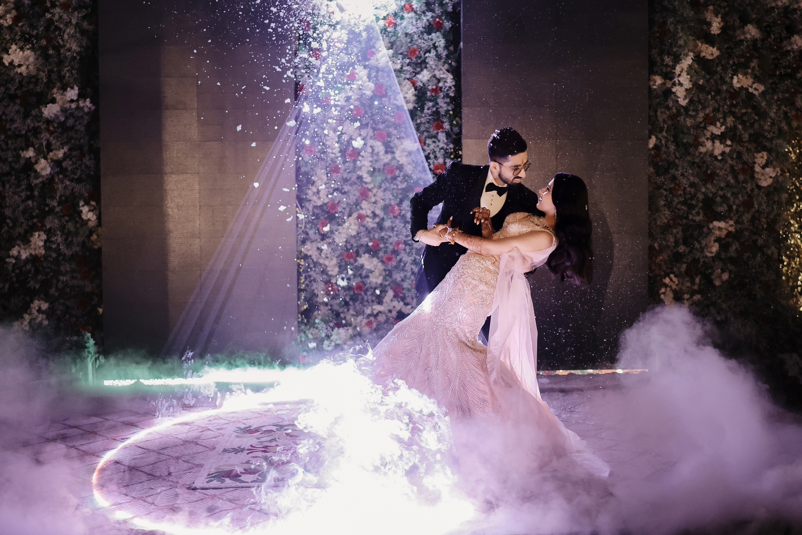 candid shot of couple performing on their sangeet