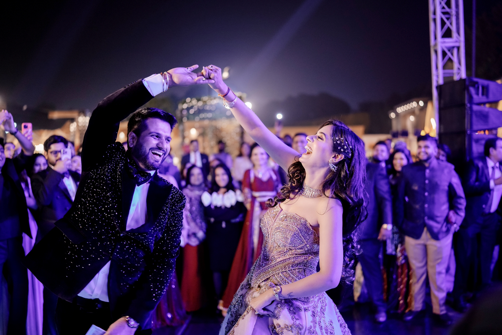 Candid shot of bride twirling the groom during their sangeet