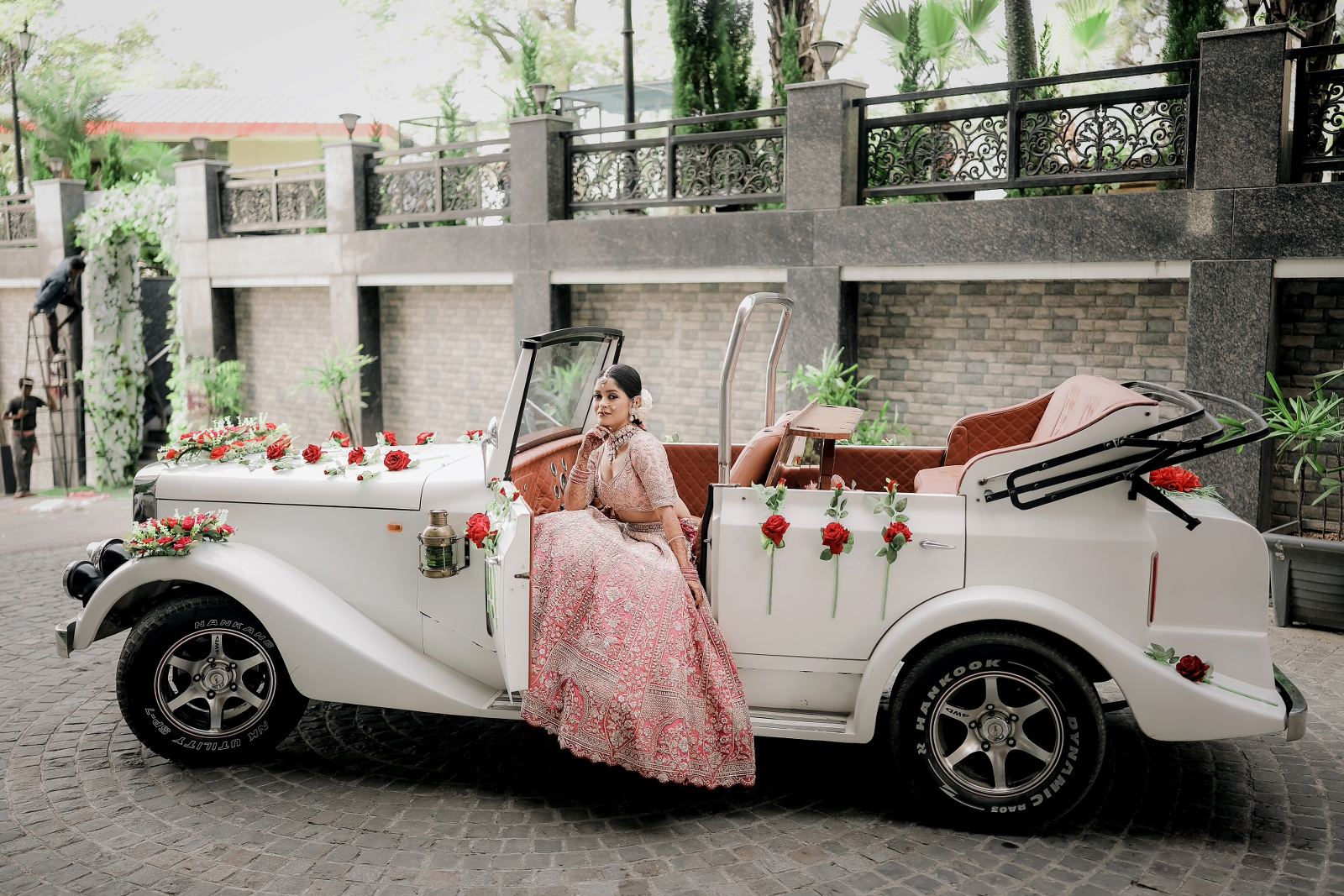 Bridal portrait taken during destination wedding in Jaipur where bride is sitting on the vintage car 