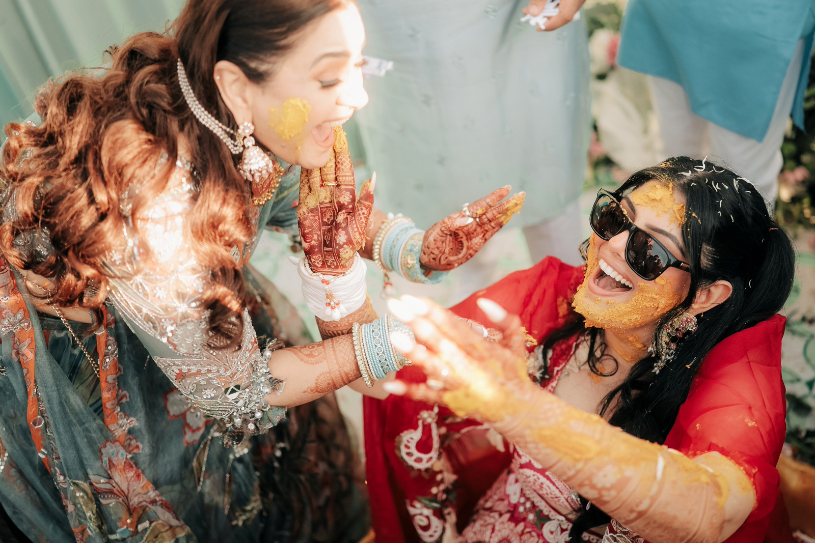 Candid playful shot of bride and her sister on HALDI CEREMONY