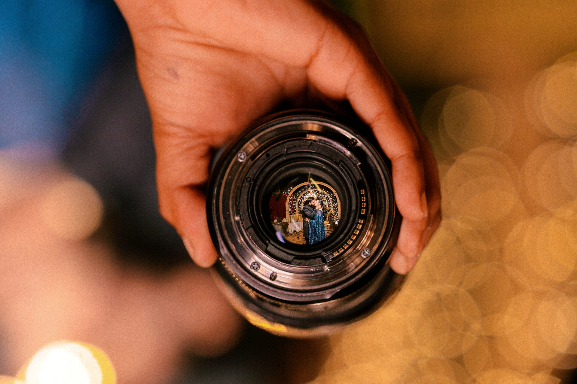 Creative shot of couple's reflection the lens of camera